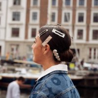 Vicky Montanari wears blue denim shirt, red bag and hair clips attends VIP guest trip with a boat to the Marimekko show during day four of the...
