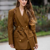 Victoria Magrath wears brown belted blazer, matching pants, bag outside Zimmermann during the Womenswear Fall/Winter 2025/2026 as part of Paris...