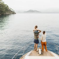 view from behind of happy family travelling with baby on board of luxury yacht. unrecognizable people - travel stock pictures, royalty-free photos & images