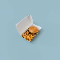 view of a hamburger and fries with open box on light blue plain background. - junk food stock pictures, royalty-free photos & images