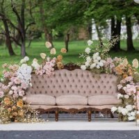 view of a sofa decorated with flowers with park on the background. - garden decoration stock pictures, royalty-free photos & images