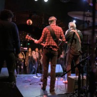 view of audience watching band from the back of the stage - concert stock pictures, royalty-free photos & images