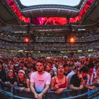 View of fans while Argentine rapper Duki performs on stage at Estadio Santiago Bernabeu on June 08, 2024 in Madrid, Spain.