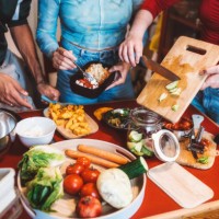 view on young woman and man preparing meal for take away on kitchen table - junk food stock pictures, royalty-free photos & images