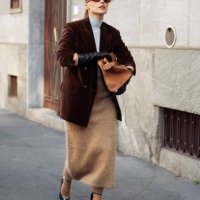 Viky Rader wears dark brown sunglasses, light blue turtle neck, dark brown velvet blazer jacket, light brown fluffy midi skirt, brown leather bag,...