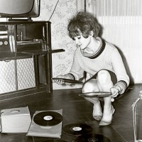 vintage photo of a young woman looking at vinyl records - fashion stock pictures, royalty-free photos & images