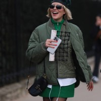 Violet Grace Atkinson seen wearing a green and black basket hat, green step jacket, green pullover dress, black tights, black shoes and shades and...
