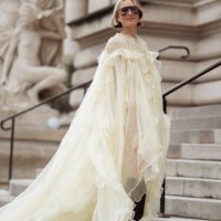 Violet Grace wears pale yellow ruffled dress, boots, sunglasses outside the Zimmermann fashion show during the Womenswear Fall/Winter 2025/2026 as...