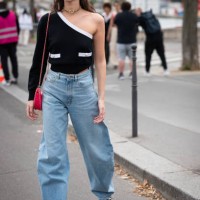 Vittoria Ceretti wears a black one sleeve top with white details, blue jeans, Adidas sneakers, black sunglasses, gold Chanel necklace and pink Chanel...