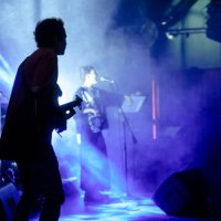 vocal singer performing on stage with colorful stage lights. - concert stock pictures, royalty-free photos & images