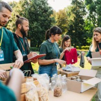 volunteers are working together at the food and clothes bank - food stock pictures, royalty-free photos & images