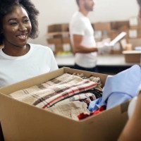 volunteers carrying clothing - home decoration stock pictures, royalty-free photos & images