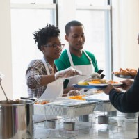 volunteers serving food in cafeteria - food stock pictures, royalty-free photos & images