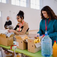 volunteers sorting, packing clothes in cardboard boxes - food stock pictures, royalty-free photos & images