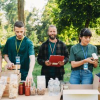 volunteers teamwork are working together in a food and clothes bank - food stock pictures, royalty-free photos & images