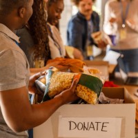 volunteers working together to organize boxes with donations - food stock pictures, royalty-free photos & images