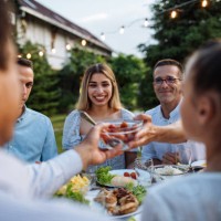 à votre santé! les gens dînent à l’extérieur dans le jardin et trinquent avec du vin, du jus et d’autres boissons - garden decoration photos et images de collection
