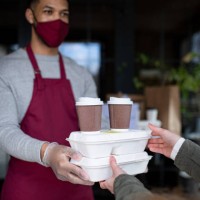 waiter giving take away food to customer in restaurant, coronavirus and new normal concept. - junk food stock pictures, royalty-free photos & images