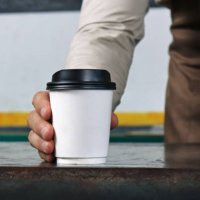 waiter holding and serving a paper cup of hot coffee - junk food stock pictures, royalty-free photos & images