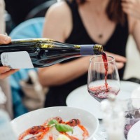waiter pouring wine for customers in luxury outdoor restaurant - food stock pictures, royalty-free photos & images