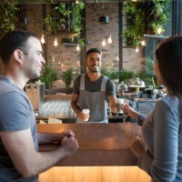 waiter serving coffee to a couple at a cafe - junk food stock pictures, royalty-free photos & images