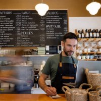 waiter working at a cafe and writing down an online order - junk food stock pictures, royalty-free photos & images
