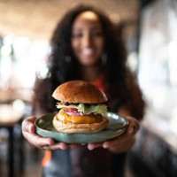 waitress holding / showing a sandwich - junk food stock pictures, royalty-free photos & images