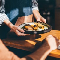 waitress serving food in a restaurant. - food stock pictures, royalty-free photos & images