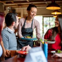 waitress serving food to a group of customers at a restaurant - food stock pictures, royalty-free photos & images