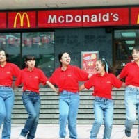 Waitresses from the US fastfood giant McDonald's dance outside an outlet in Beijing 03 October 2000 to attract more customers during festivities to...