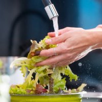 washing lettuce under the faucet in kitchen sink - food stock pictures, royalty-free photos & images