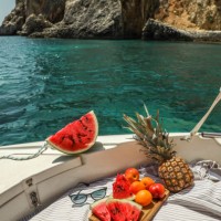 watermelon and fruit picnic on boat in greek lagoon - food stock pictures, royalty-free photos & images