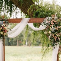 wedding arch decorated with flowers and greenery in rural area - garden decoration stock pictures, royalty-free photos & images