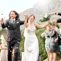 wedding, confetti and celebration with bride and groom celebrating, just married with friends and family at scenic venue. happy, fun and rose petals with couple celebrating success marriage ceremony - garden decoration stock 
