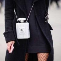 White Chanel bag shaped as a fragrance bottle is seen, outside Chanel, during Paris Fashion Week Womenswear Fall/Winter 2018/2019, on March 6, 2018...