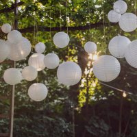 white paper lanterns hanging in trees in the garden. decoration service. garden party, summer festival, wedding. - garden decoration stock pictures, royalty-free photos & images