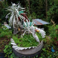 white swan-shaped pot plant holder made from a used car tire - garden decoration stock pictures, royalty-free photos & images