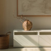 wicker vase on a sideboard below a picture frame and basket in a living room - home decoration stock pictures, royalty-free photos & images