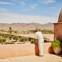 wide shot man enjoying view from rooftop terrace of luxury resort - travel stock pictures, royalty-free photos & images