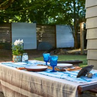 wide shot of a table set up for dinner in a back yard at sunset. - garden decoration stock pictures, royalty-free photos & images