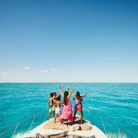 wide shot of smiling family dancing on bow of yacht during vacation - travel stock pictures, royalty-free photos & images