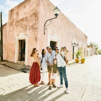 wide shot of smiling multigenerational family taking selfie in street while exploring town during vacation - travel stock pictures, royalty-free photos & images