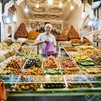 wide shot of smiling pastry shop owner taking payment from customer - food stock pictures, royalty-free photos & images