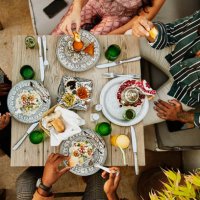 wide shot overhead view of friends sharing dinner at rooftop restaurant - food stock pictures, royalty-free photos & images