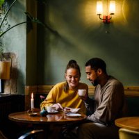wide shot with copy space of couple sharing a dessert in cafe - coffee stockfoto's en -beelden