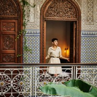 wide shot woman standing in bedroom window in raid while on vacation - travel stock pictures, royalty-free photos & images