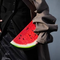 Willabelle On wears skirt with graphic print, red melon bag, cut out grey trench coat outside Moschino during the Milan Fashion Week Womenswear...