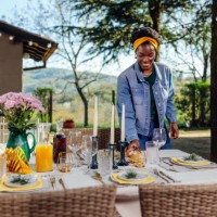 woman arranging table for outdoors gathering - garden decoration stock pictures, royalty-free photos & images