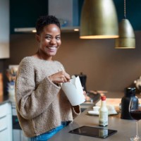 woman at home relaxing and eating take away food. - junk food stock pictures, royalty-free photos & images