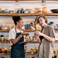 woman buying craft product from owner in store - home decoration stock pictures, royalty-free photos & images